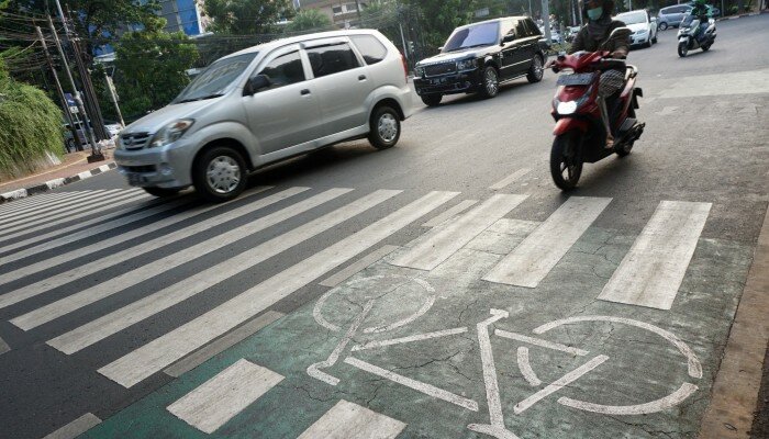 Pengendara kendaraan bermotor melintasi jalur sepeda di Jalan Melawai, Jakarta Selatan