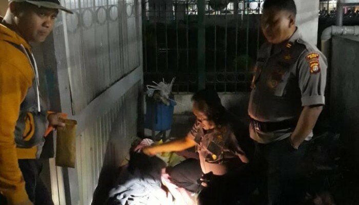 Petugas Piket Polsek Pancoran Mas memeriksa jasad pria tanya identitas di lokasi kejadian (angga)